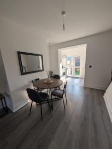 a dining room with a table and chairs in a room at Entire Home in Denton in Denton