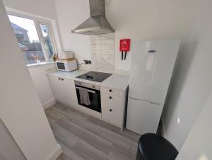 a kitchen with a white refrigerator and a microwave at Entire Home in Denton in Denton
