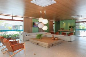 a living room with a couch and a table at Luxury Flat with Breakfast! in Ipojuca