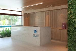 a lobby with a reception desk in a building at Luxury Flat with Breakfast! in Ipojuca +59 photos