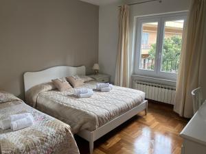 a bedroom with two beds and a window at Villa Orsini in Tor Vergata