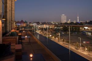 a balcony with a view of a city at night at Hotel AMANO Grand Central in Berlin