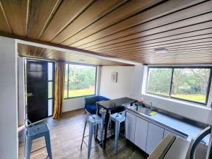 a room with a table and chairs and windows at Volterra Guatavita in Guatavita