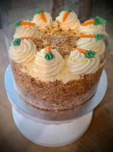 a carrot cake on a plate on a table at Sunset Ridge - Luxury Geodesic Dome set in the beautiful countryside in Porkellis