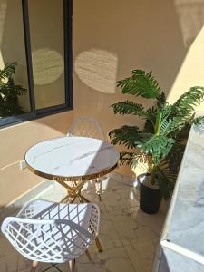 a patio with a table and chairs and plants at Westwood Homes in Kilifi