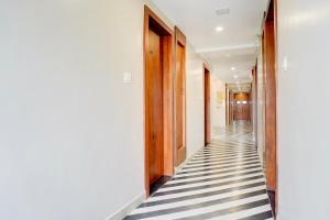 a hallway with black and white checkered floor at Palette by CheckIn Patel Nagar Bhopal in Bhopal +50 photos
