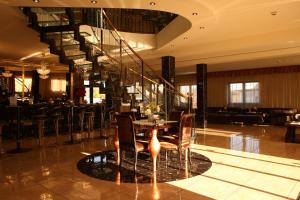 a lobby with a table and chairs and a staircase at Apartment Kotva in Bratislava