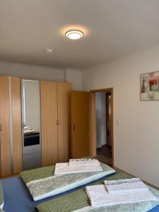 a room with two beds and cabinets with towels at Ferienwohnung Florion 4 in Bernburg