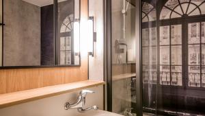 a bathroom with a sink and a shower at Campanile NATURE - Martigues in Martigues