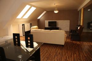 a living room with a white couch and a table at Apartment Kotva in Bratislava