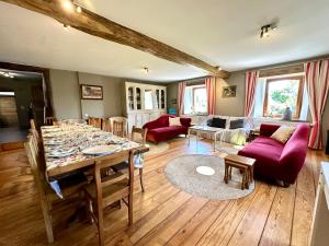 a living room with a table and a couch at Moulin de Meeffe in Wasseiges