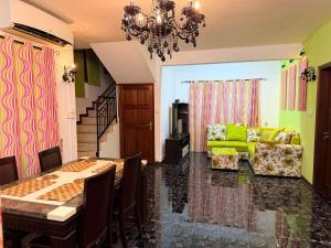 a living room with a table and a green couch at Sea Bliss Villa1 in Pereybere