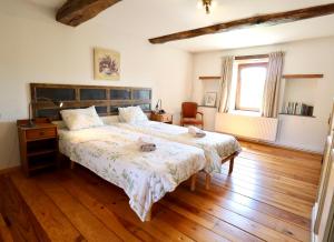 a bedroom with two beds and a window at Moulin de Meeffe in Wasseiges