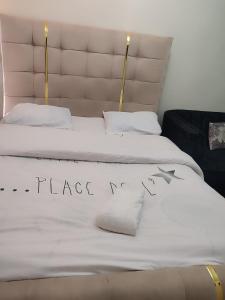 two beds with white sheets with a peace sign on them at Harmony Haven in Rungiri