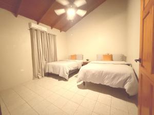a bedroom with two beds and a ceiling at TheWinterHouse in Crown Point