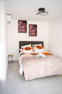 a white bedroom with a large bed with pillows at Villa Champan in La Ciotat +36 photos