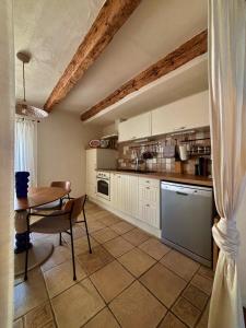 a kitchen with a table and a table and a dining room at Franka Apartment in Piran