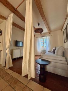 a living room with a couch and a table at Franka Apartment in Piran