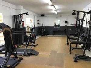 a gym with several treadmills and exercise bikes at Anitas Seaview Paradise in La Línea de la Concepción