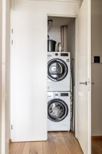 a washer and dryer in a small room at BizStay Harbour I Scheveningen Apartments in Scheveningen