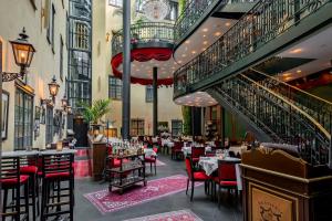 a restaurant with tables and chairs in a building at Hotel Kungsträdgården in Stockholm
