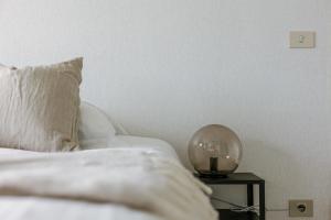 a bedroom with a bed and a table with a globe on it at Casiola - Apartment with lake view & common indoor pool in Knokke-Heist