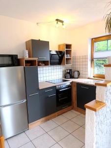a kitchen with a stainless steel refrigerator and a stove at FeWO Koeppe in Kopp