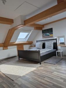 a bedroom with a bed in a room with wooden ceilings at Drive & Dream Nürburgring in Drees