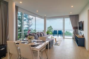 a living room with a couch and a table at The Residence Seaview in Nathon Bay