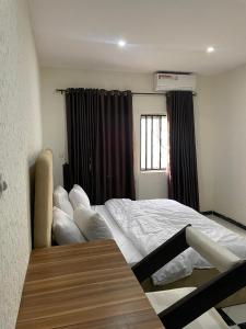 a bedroom with a bed and a window at The Grace Villa in Abeokuta
