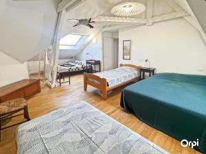 a bedroom with two beds in a room at REF 495 Quéven type 7 manor house in Quéven
