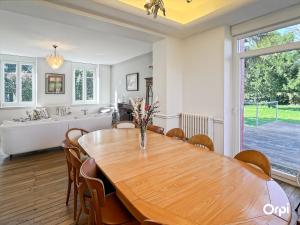 a dining room with a table and a bath tub at REF 495 Quéven type 7 manor house in Quéven