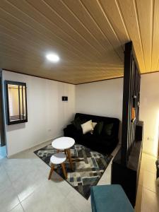 a living room with a couch and a table at Céntrico apto 202 in Tunja +3 photos