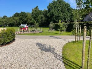 a gravel driveway with trees in a park at 't Meuleveld in Harskamp
