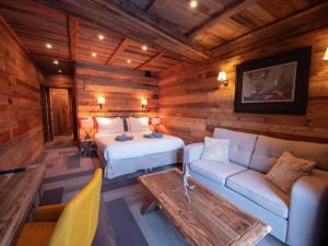a bedroom with a bed and a couch in a room at Chalet Caribou in Isola
