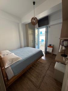 a bedroom with a bed and a door to a patio at Aristeidis villas in Foiníkion