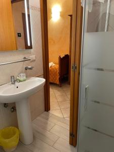 a bathroom with a sink and a mirror and a shower at Affittacamere Ramina in San Giuseppe +31 photos