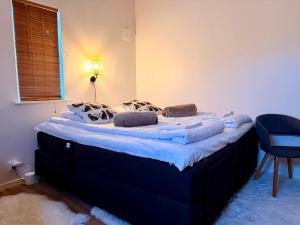 a large bed in a bedroom with a blue mattress at Vid Gekås Ullared Boende B&B in Ullared +117 photos