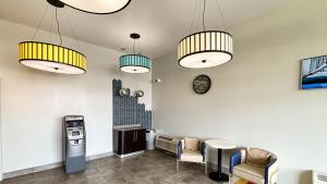 a waiting room with two lights and a ticket machine at Studio 6 Suites Lexington, Kentucky in Lexington