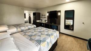 a hotel room with two beds and a bathroom at Studio 6 Suites Lexington, Kentucky in Lexington +30 photos