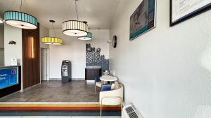 a waiting room at a fast food restaurant with tables and chairs at Studio 6 Suites Lexington, Kentucky in Lexington