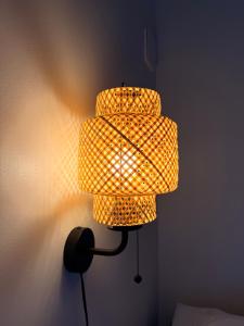 a yellow lamp is attached to a wall at Vid Gekås Ullared Boende B&B in Ullared