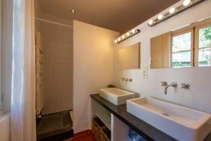 a bathroom with two sinks and a mirror at Maison avec jardin proche plages & village in Gassin