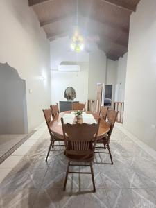a dining room with a wooden table and chairs at TheWinterHouse in Crown Point