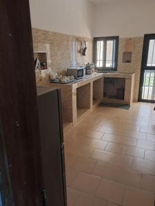 a kitchen with a tile floor and a counter top at Jamm in Saint-Louis