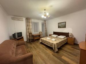 a living room with a bed and a couch at Квітка Закарпаття in Polyana