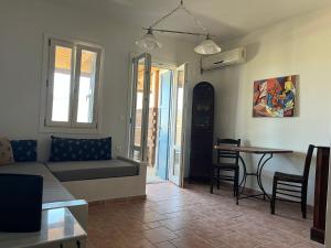 a living room with a couch and a table at Phoenix Cosy Home L in Livadi +8 photos