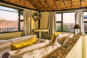 a living room with a couch and some windows at Ugab Terrace Lodge in Fingerklippe 
