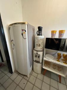 a kitchen with a small refrigerator and a coffee maker at Grey Flat Comfort in Garanhuns