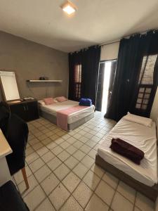 a hotel room with two beds in a room at Grey Flat Comfort in Garanhuns